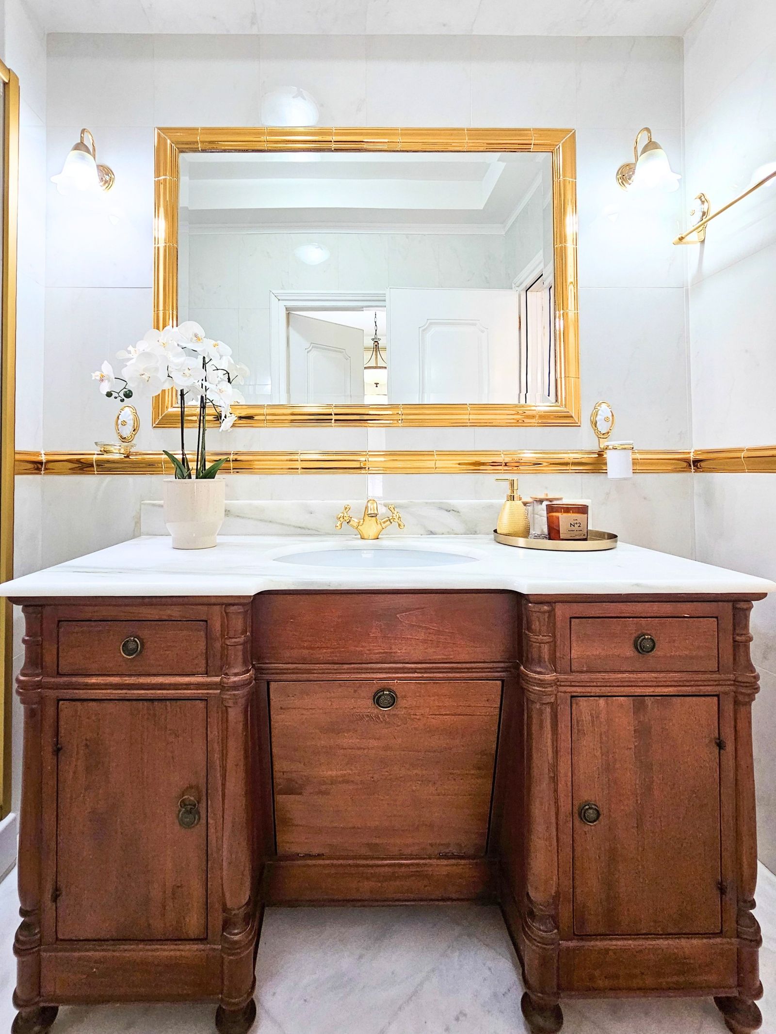 Ensuite bathroom with marble and gold vanity
