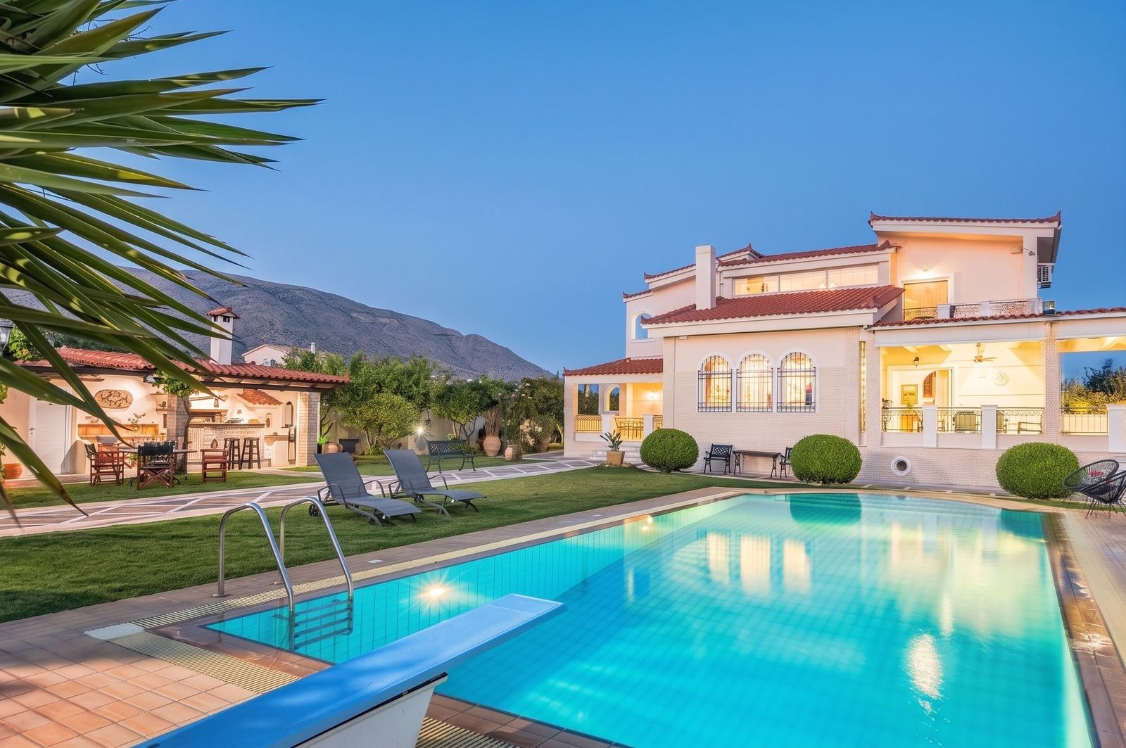 Renko Royal Villa residence with pool and garden at blue hour
