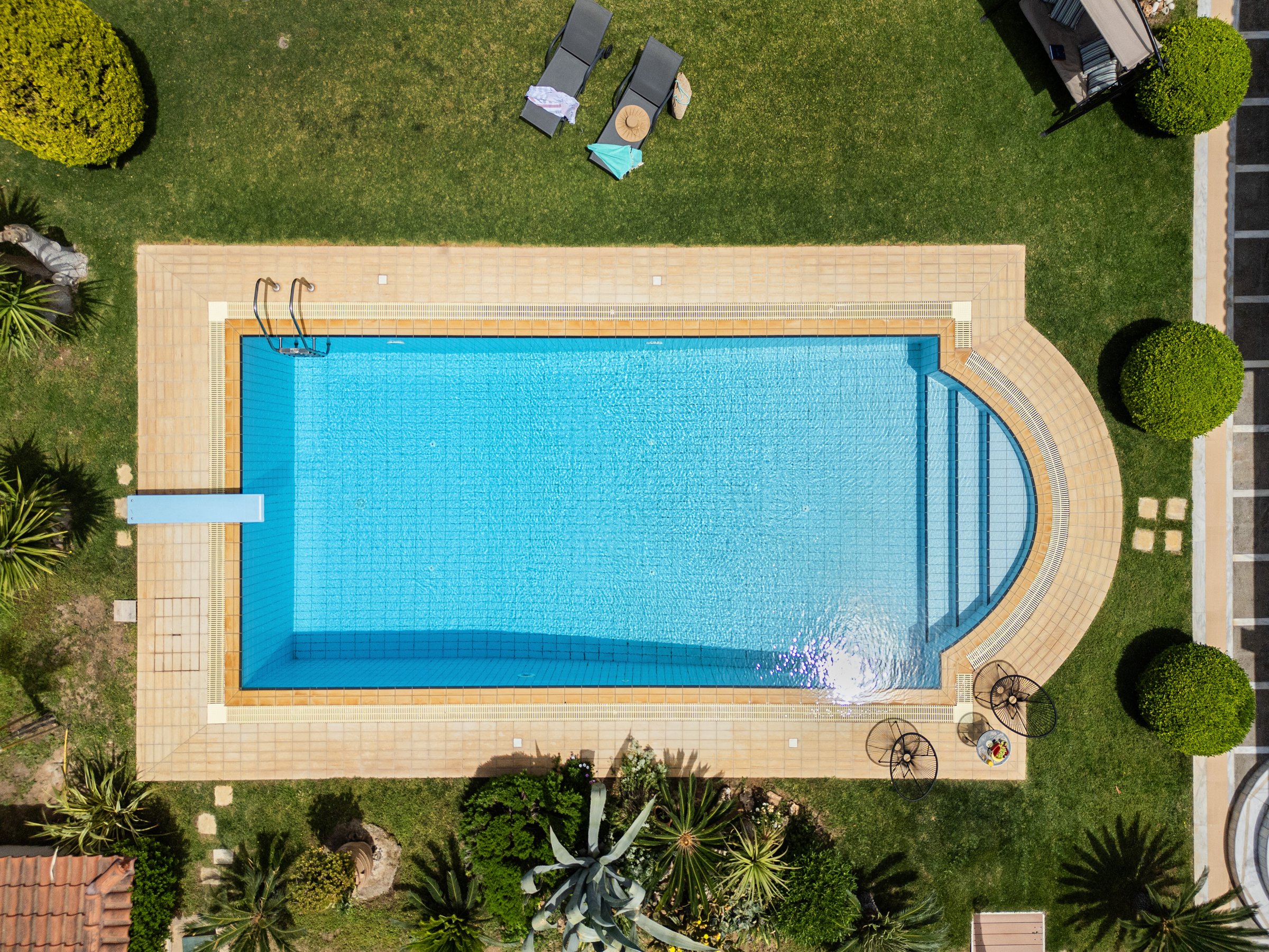 Renko Royal Villa aerial view of private infinity pool and lush garden, Lagonisi Athens Greece